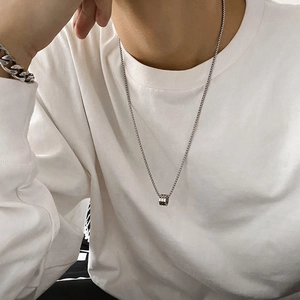 Silver stainless steel hip-hop necklace with cylindrical pendant worn by a model