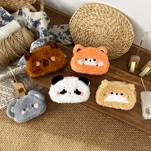 Detail showing five different plush animal purses with embroidery and zipper closure
