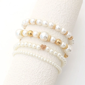 Chic 4-piece set of white faux pearl bracelets with gold heart charms and CCB beads