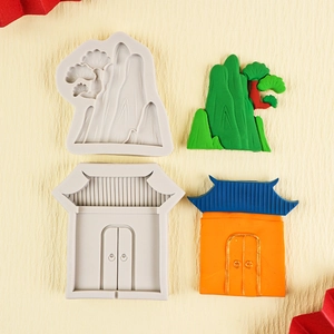 Detalle de moldes de silicona chinos con formas de montaña y puerta tradicional