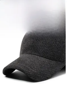 Detail of grey wool baseball cap showing firm brim and premium stitched texture