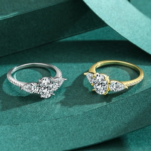 Classic 925 silver oval faux diamond rings in gold and silver finishes on green background