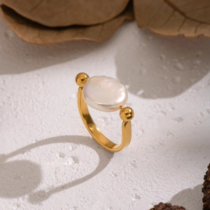 Elegant gold U-shape stainless steel ring with a natural baroque pearl on white stone