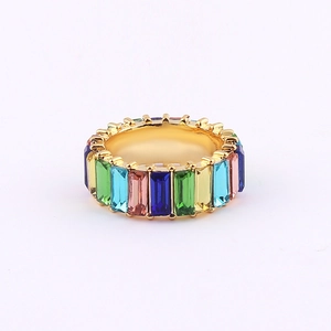 Detail of gold-plated ring with multi-colored baguette-cut rainbow zircon stones
