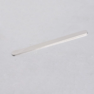 Macro detail of polished stainless steel blank bar with smooth rounded edges for DIY jewelry