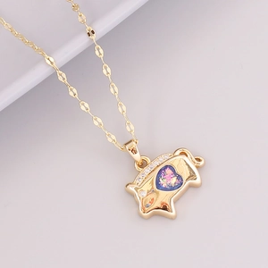Detailed macro of 18K gold pig pendant with a purple heart gem and tiny crown jewels