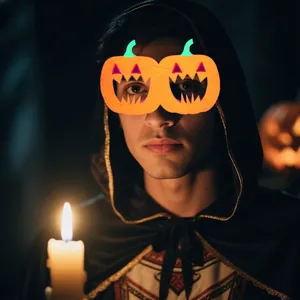 Detail of Halloween costume set with pumpkin glasses and hooded cloak in candlelight
