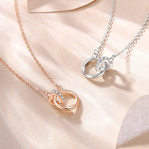 S925 sterling silver Mobius heart necklace in rose gold and silver on silk background