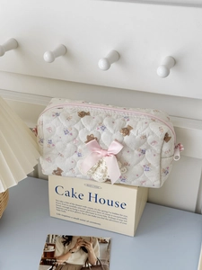 Quilted heart pattern bear cosmetic bag with pink bow and floral prints on box