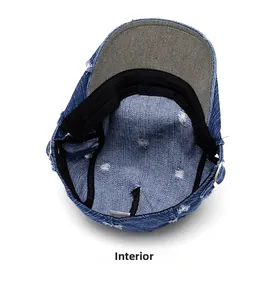 Detail view of denim newsboy cap showing internal sweatband and metal adjustable buckle