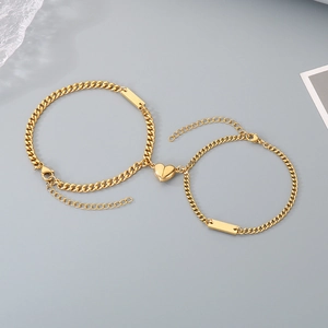 Detailed view of golden curb chain magnetic heart bracelets with engravable square tags