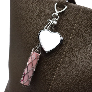 Silver heart mirror bag charm with metal mesh lipstick holder on brown leather bag