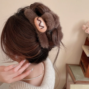 Close-up of soft brown flocked acrylic hair claw clip with cream wavy pattern