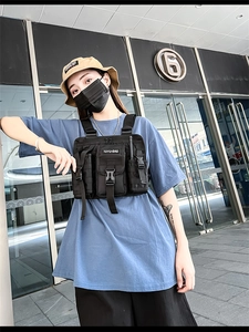 Close-up of tactical chest bag with multi-pocket design and adjustable buckle straps