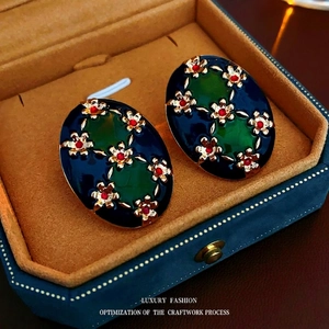 Vintage enamel oval earrings with blue-green glaze and golden flower details