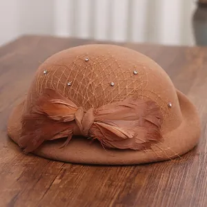 Elegant brown wool felt fascinator hat with vintage mesh veil and feather bow decoration