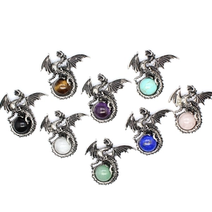 Detail of eight antique silver dragon claw pendants holding colorful gemstone spheres