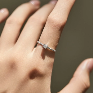 Minimalist S925 sterling silver beaded ring featuring a square VVS1 moissanite on finger