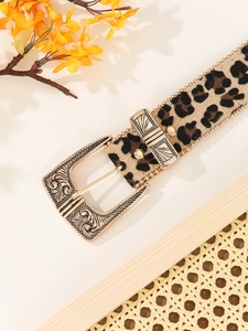 Close-up of leopard print belt with vintage engraved gold metal buckle and fur texture