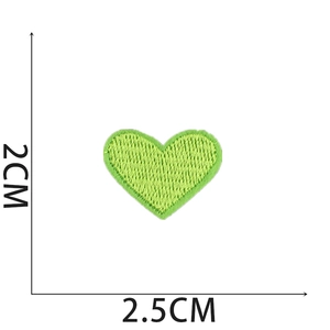 Close-up of small green heart embroidery patch showing detailed texture and 2x2.5cm size