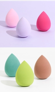 Detailed view of six colorful teardrop makeup sponges in pink, purple, and green tones