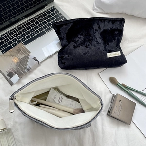Close-up of velvet makeup bags showing soft texture and large interior storage capacity