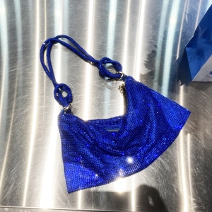 Detailed view of blue sparkling rhinestones on hobo shoulder bag with crystal strap