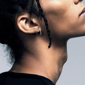 Minimalist silver thorn hoop earrings shown on model with polished metal finish