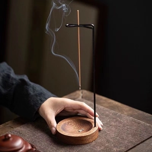 Minimalist wooden incense burner holder with black metal stand and burning stick incense