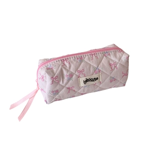 Pink floral quilted cotton pencil case with bow patterns and silk ribbon zipper pull