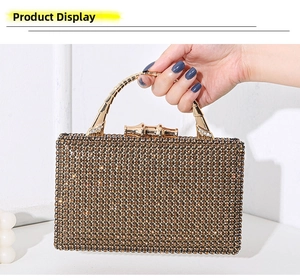 Macro shot of luxury evening clutch featuring brown rhinestones and bamboo gold handle