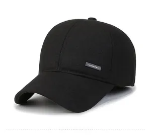 Close-up of a black winter baseball cap featuring a silver metal SPORTS emblem on the side