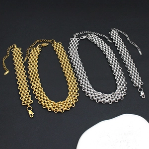 Golden and silver woven corn chain necklace and bracelet sets on a textured black surface