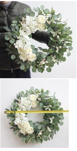 Detail shot showing 48cm diameter of white rose and eucalyptus wreath with measuring tape