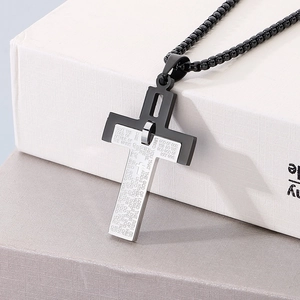 Detail shot of two-tone stainless steel cross pendant with engraved scripture verses
