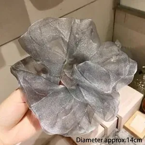 Detail of silver-grey organza scrunchie showing large 14cm diameter and shimmering texture