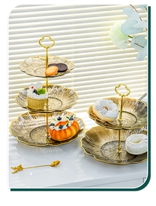 Detail of amber glass tiered dessert stand with gold trim and metallic handle