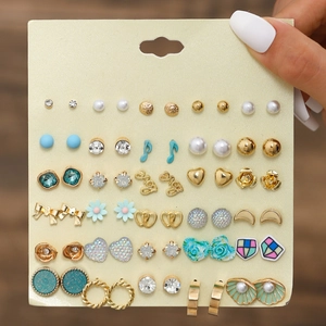 Detail of 20 pairs earring set featuring pearls, rhinestones, and metal flower designs