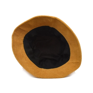Detailed view of ginger yellow corduroy bucket hat with black inner lining and neat stitching