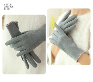 Detail of grey winter gloves with pink edge stitching and touch screen function