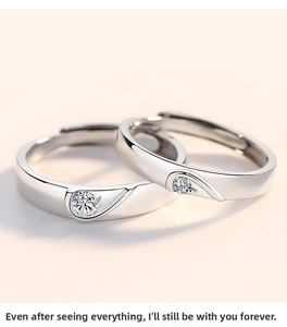 Macro shot of silver couples rings featuring single round diamonds and adjustable bands