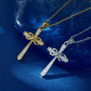 Macro detail of infinity cross pendant with pavé cubic zirconia in gold and silver