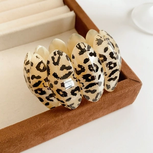 Detail of vintage leopard print oval link bracelet on a brown velvet jewelry display box