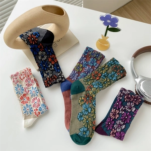 Detail of vintage floral embroidered crew socks in multiple colors and soft cotton texture