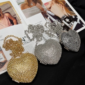 Detail of heart-shaped rhinestone evening bags with shimmering crystals and chain