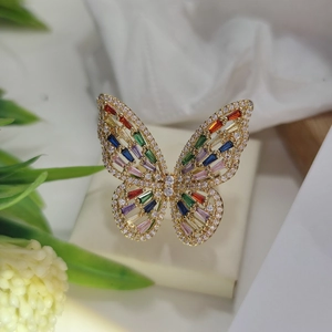 Detailed close-up of a golden butterfly ring set with vibrant multi-colored gemstones