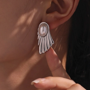 Elegant silver fan-shaped wing earrings with large white pearls for a vintage aesthetic