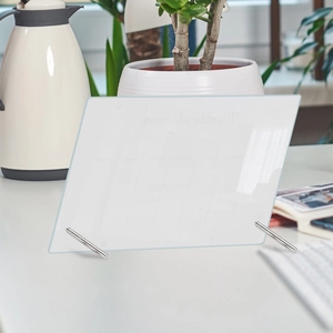 Close-up of a white acrylic weekly desk planner board with sturdy metal stands