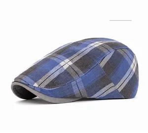 Detail of blue and grey plaid beret hat with a solid grey brim in vintage style