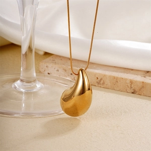Polished gold water drop pendant necklace on sleek snake chain with elegant metal finish